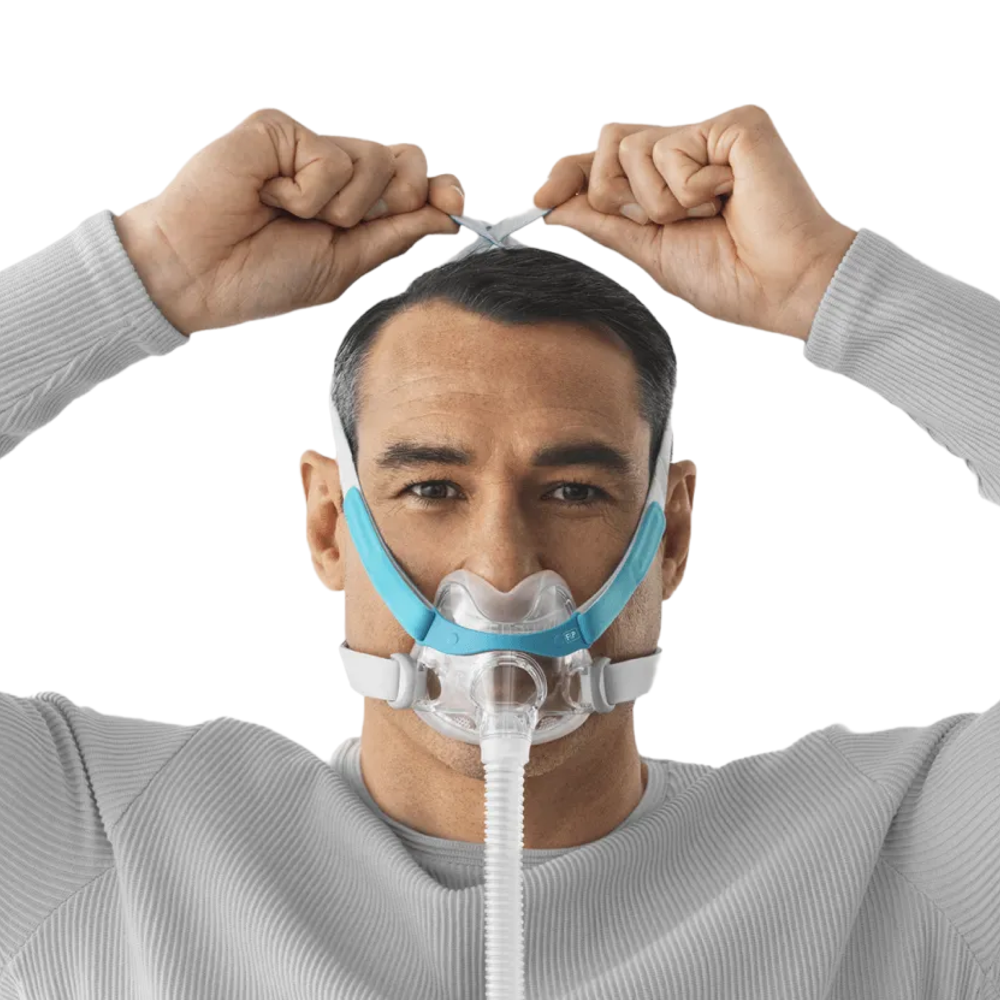 Image of a man wearing a F&P Evora Full Face Mask and adjusting the size of its headgear by pulling the ends on top of his head.